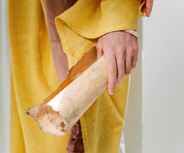 Ancient scroll and yoga symbols representing wisdom.